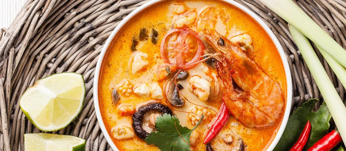 Tom yum soup with shrimp, lime, mushrooms, and fresh herbs